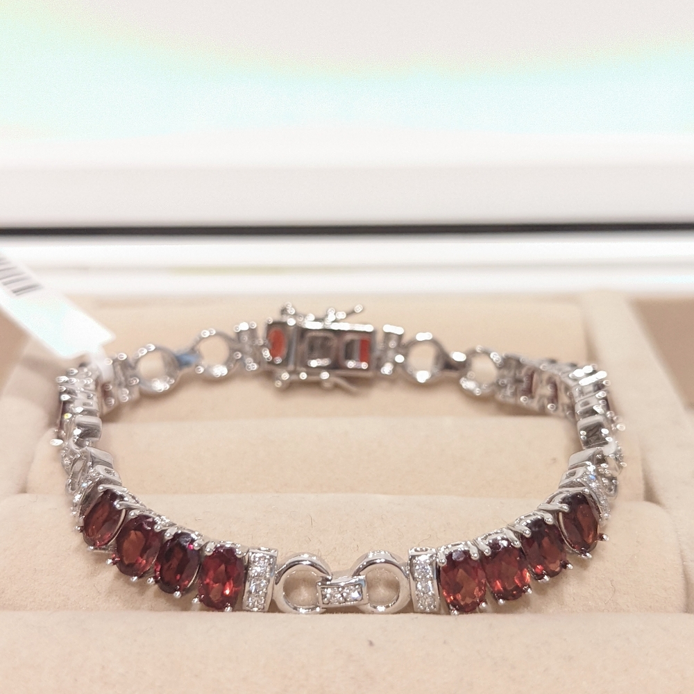 Garnet and status link bracelet with white zircon accents.